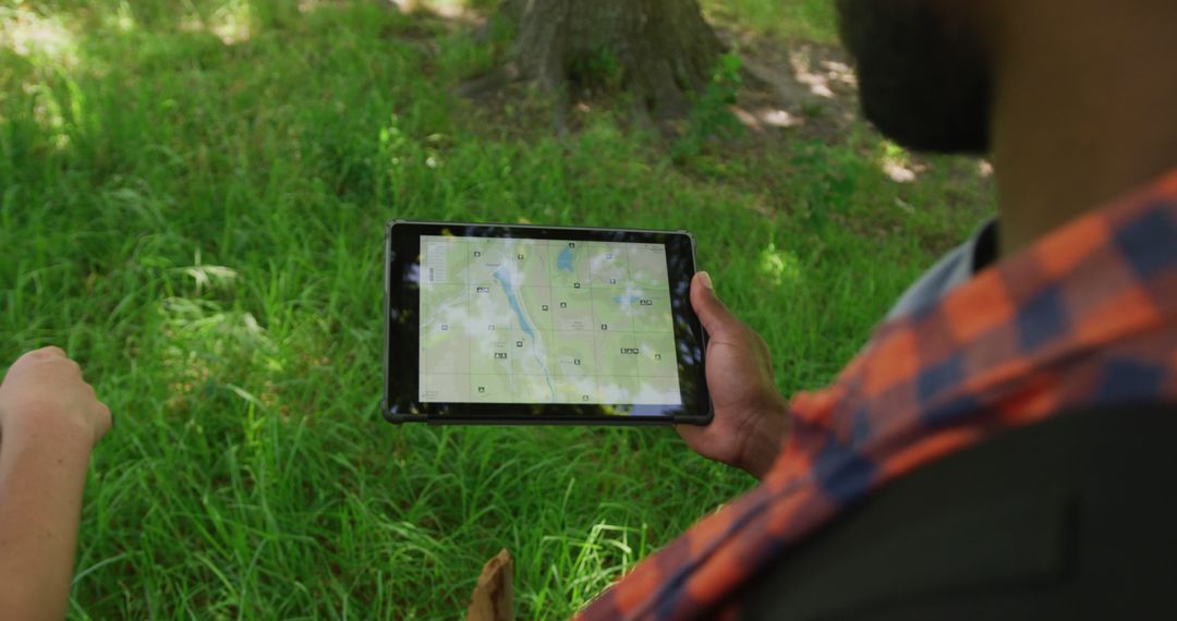 Man using digital tablet for navigation during outdoor adventure - Free Images, Stock Photos and Pictures on Pikwizard.com