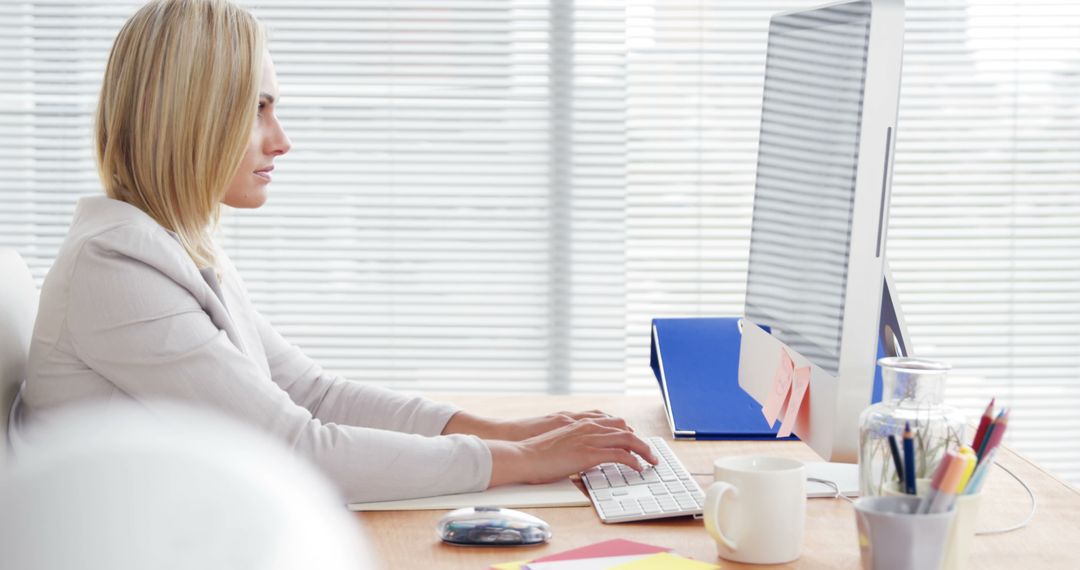 Professional Woman Working on Computer in Modern Office - Free Images, Stock Photos and Pictures on Pikwizard.com