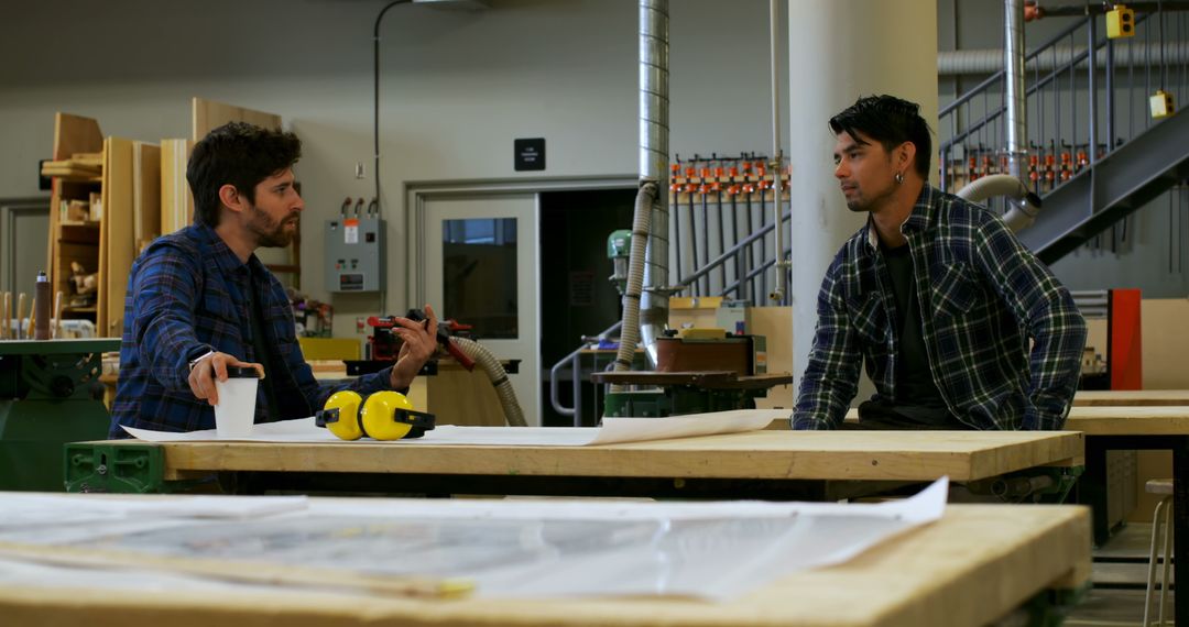 Craftsmen Discussing Woodworking Project in Workshop - Free Images, Stock Photos and Pictures on Pikwizard.com