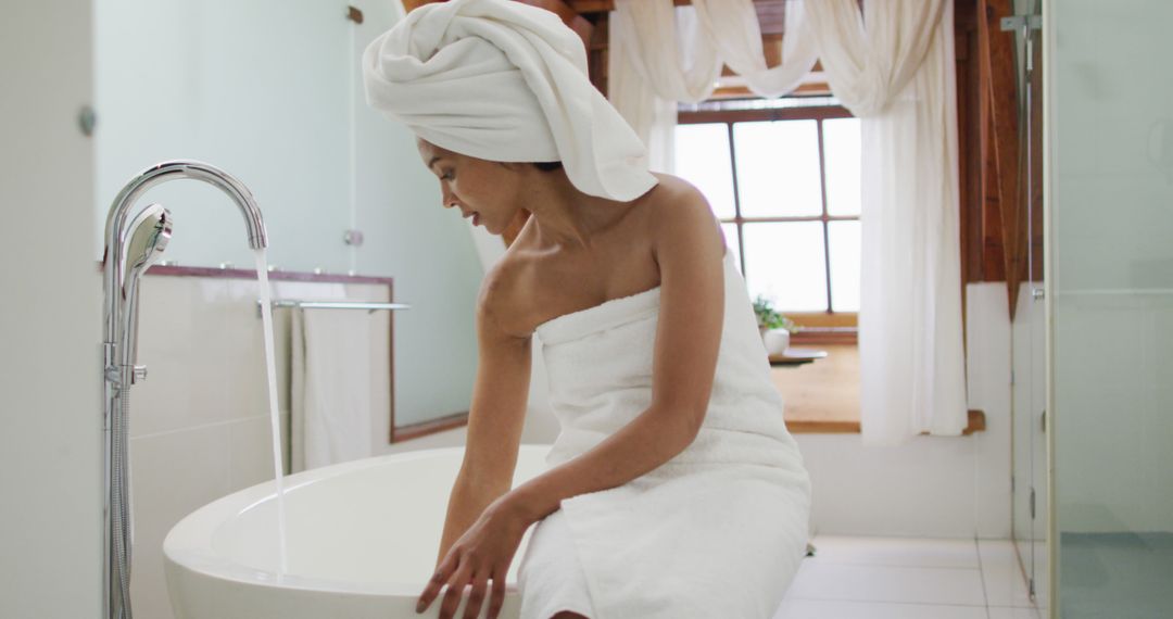 Relaxed Woman In Spa-Like Bathroom Preparing A Bathtub - Free Images, Stock Photos and Pictures on Pikwizard.com