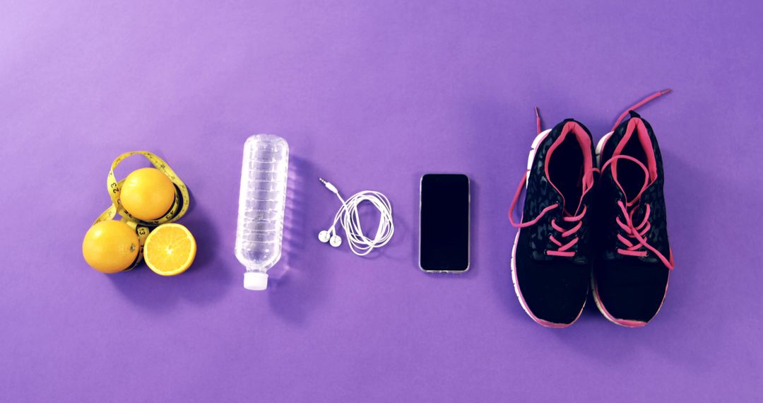 Fitness Essentials on Purple Background Featuring Shoes, Water Bottle, and Smartphone - Free Images, Stock Photos and Pictures on Pikwizard.com