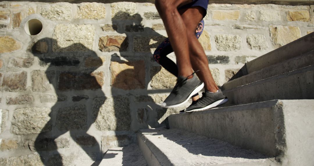 Close-Up of Athlete Running Up Stone Staircase Outdoors - Free Images, Stock Photos and Pictures on Pikwizard.com