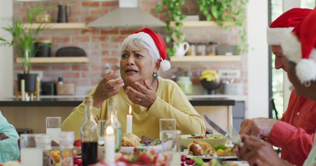 Senior Woman in Santa Hat Expressing Surprise at Christmas Dinner - Free Images, Stock Photos and Pictures on Pikwizard.com