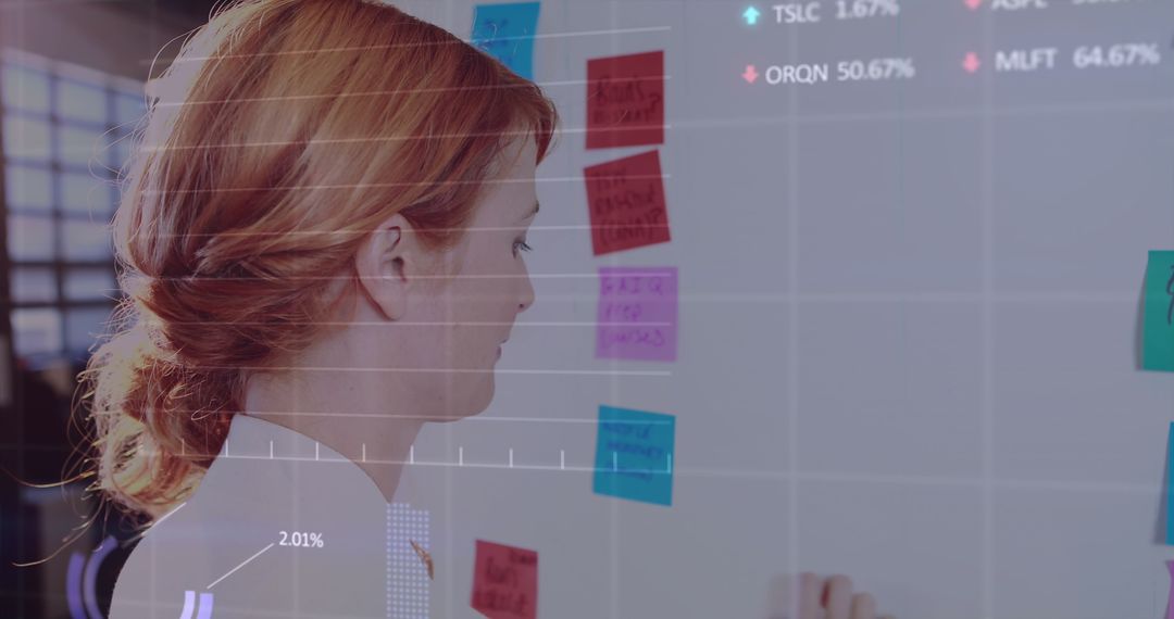 Businesswoman Analyzing Data On Sticky Notes In Office