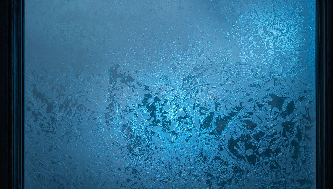 Frosted Window Pane Glowing Cyan with Intricate Ice Crystal Patterns and Dark Frames