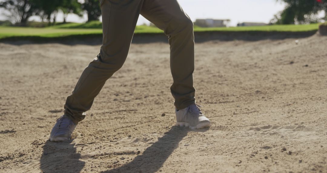 Golf Player Practicing in Bunker on Sunny Course