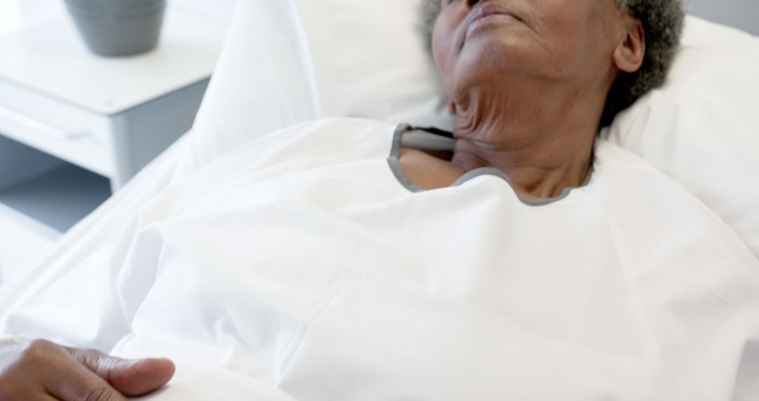 Elderly Patient Resting in Hospital Bed Receiving Care - Free Images, Stock Photos and Pictures on Pikwizard.com