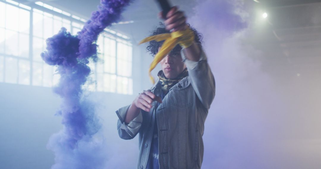 Young Man Creating Purple Smoke with Flares Indoors - Free Images, Stock Photos and Pictures on Pikwizard.com