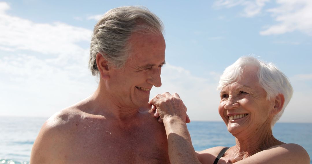 Smiling Senior Couple Enjoying Beach Vacation - Free Images, Stock Photos and Pictures on Pikwizard.com