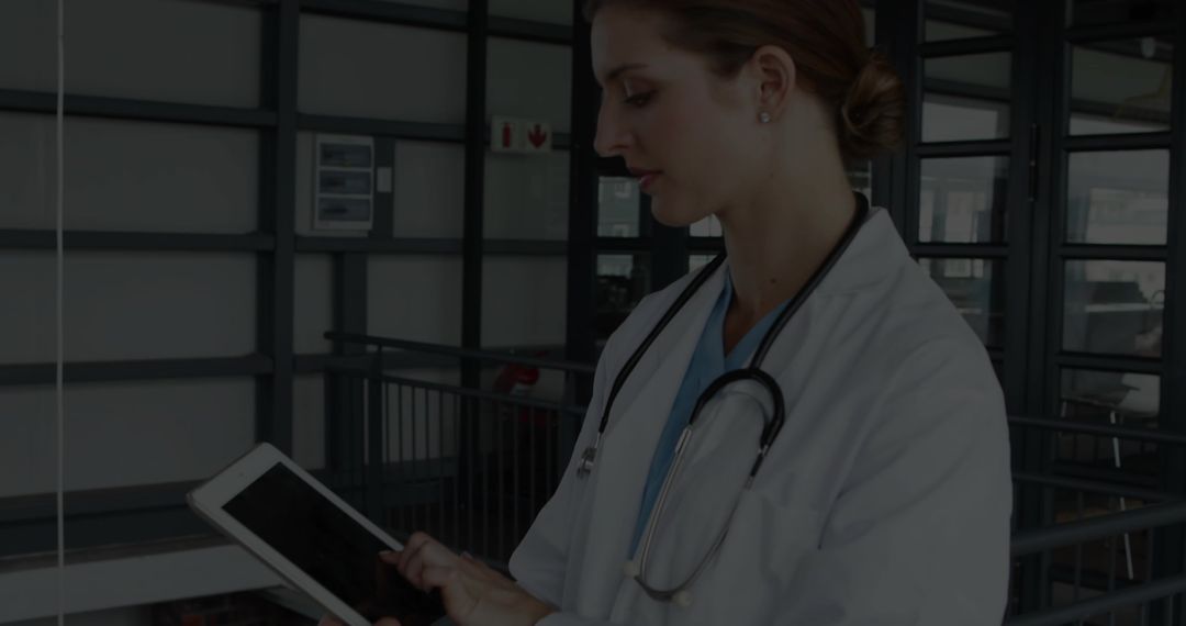 Confident Doctor Using Tablet in Modern Hospital Environment