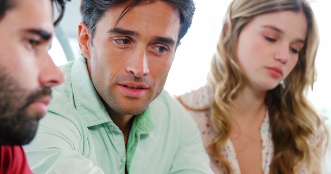 Friends Engaging in Conversation Over Shared Meal Indoors