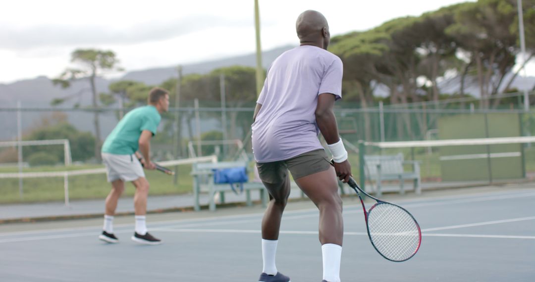 Men Playing Tennis on Outdoor Court in Sportswear - Free Images, Stock Photos and Pictures on Pikwizard.com