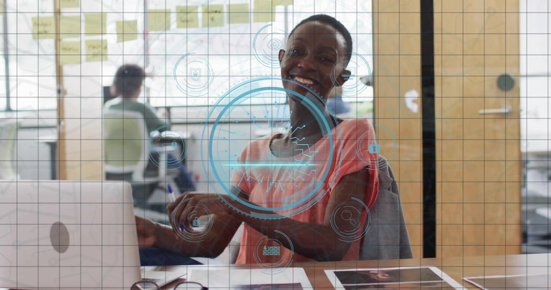 Smiling woman using laptop in coworking space with augmented reality teamwork interface