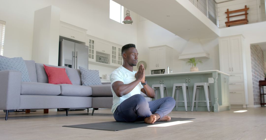 Man Practicing Meditation at Home in Modern Living Room - Free Images, Stock Photos and Pictures on Pikwizard.com