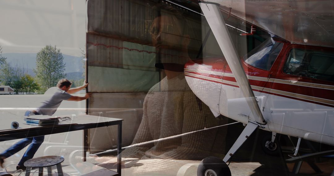 Man Opening Hangar with Propeller Plane and Piano Artistic Reflection