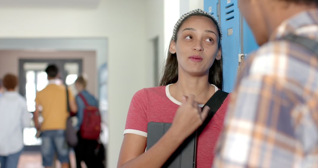 Teenage Students Engaging in Corridor Discussion at High School