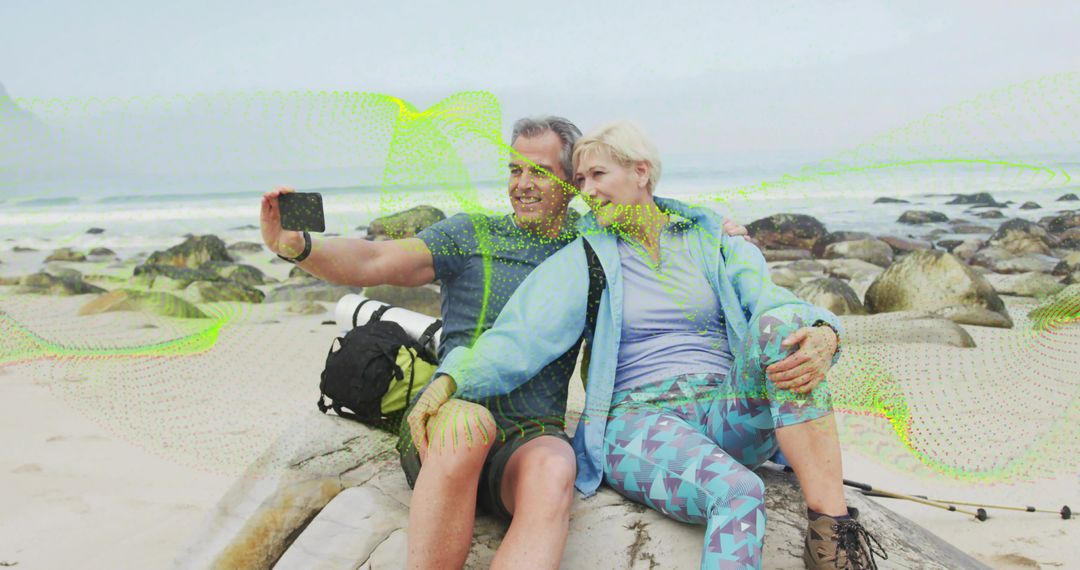 Posing Couple Hiking and Capturing Beach Selfie with Smartphone