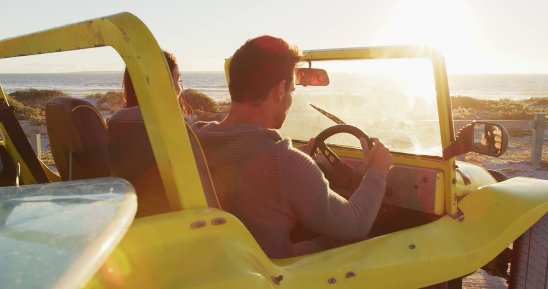 Couple Driving Beach Buggy During Sunset - Free Images, Stock Photos and Pictures on Pikwizard.com