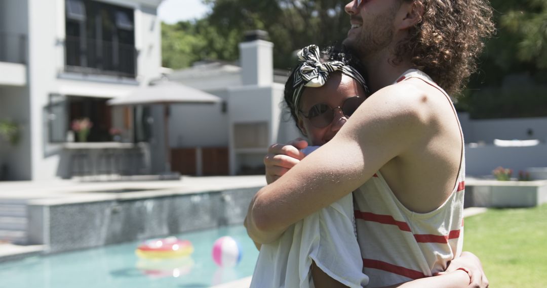 Diverse Couple Embracing By Pool on Sunny Day