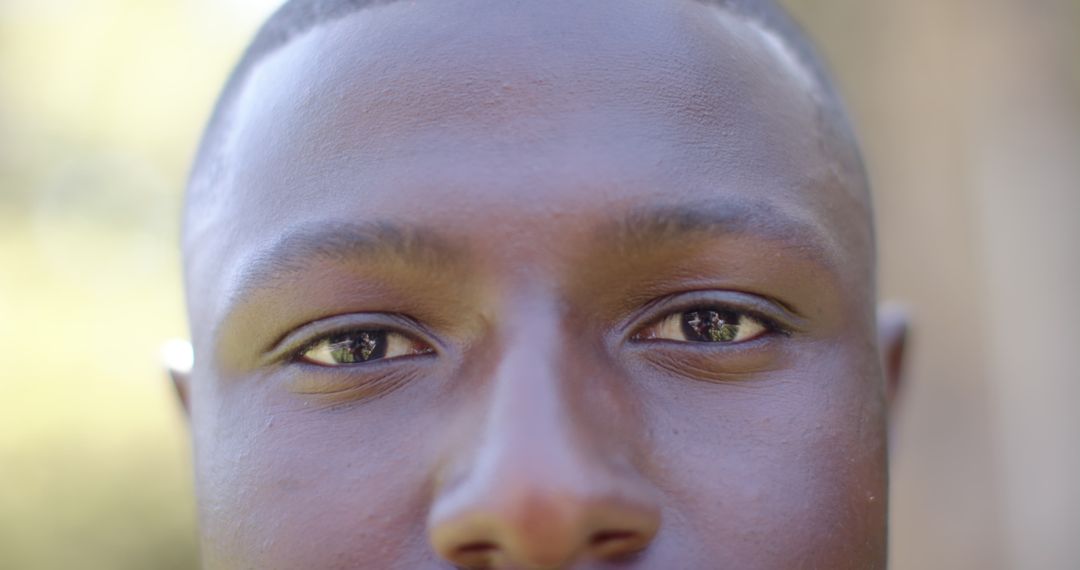 Close-Up Portrait Highlighting Eye Reflections and Serene Expression