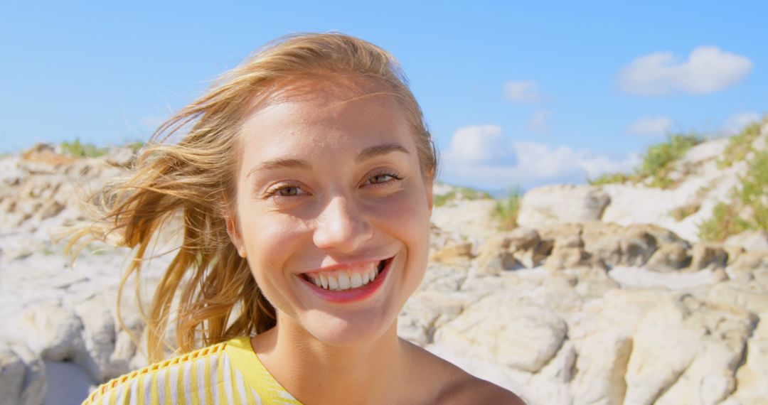 Cheerful Young Woman Smiling on Sunny Beach - Free Images, Stock Photos and Pictures on Pikwizard.com