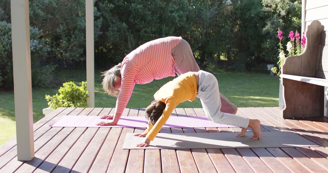 Grandparent and Grandchild Doing Yoga Outdoors on Wooden Deck - Free Images, Stock Photos and Pictures on Pikwizard.com