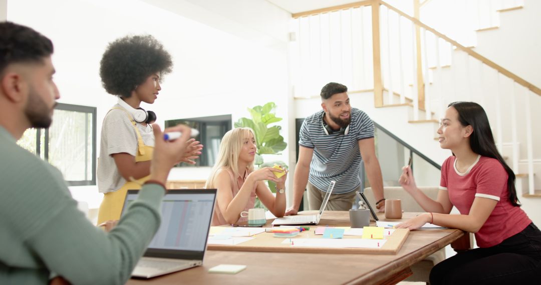 Diverse Coworkers Collaborating Around Office Table