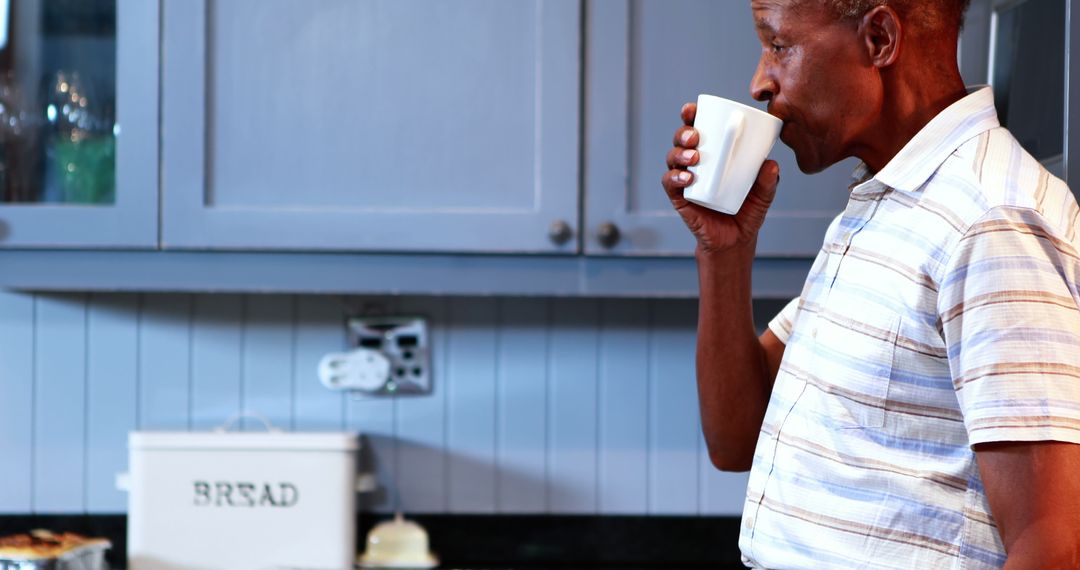 Elderly Man Drinking Coffee in Kitchen - Free Images, Stock Photos and Pictures on Pikwizard.com