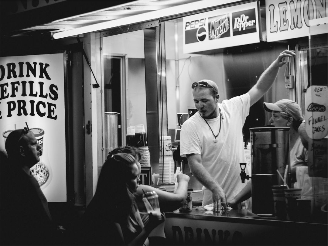 Man Serving Customers at Lemonade Stand in Black and White - Free Images, Stock Photos and Pictures on Pikwizard.com