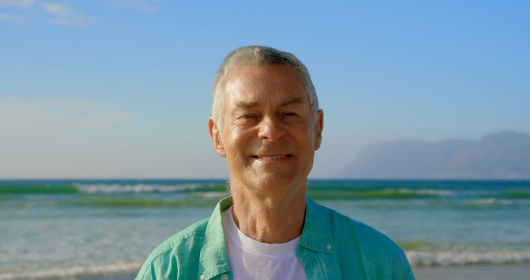 Joyful Senior Man Enjoying Sunny Beach Day