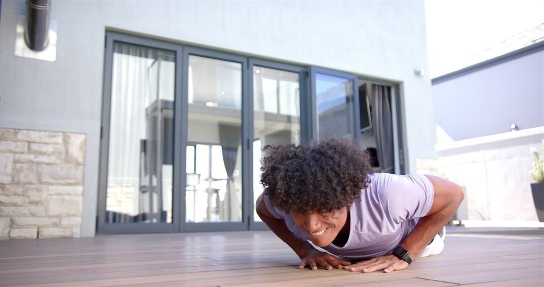Man Doing Push-Ups on Wooden Floor in Modern Home Setting