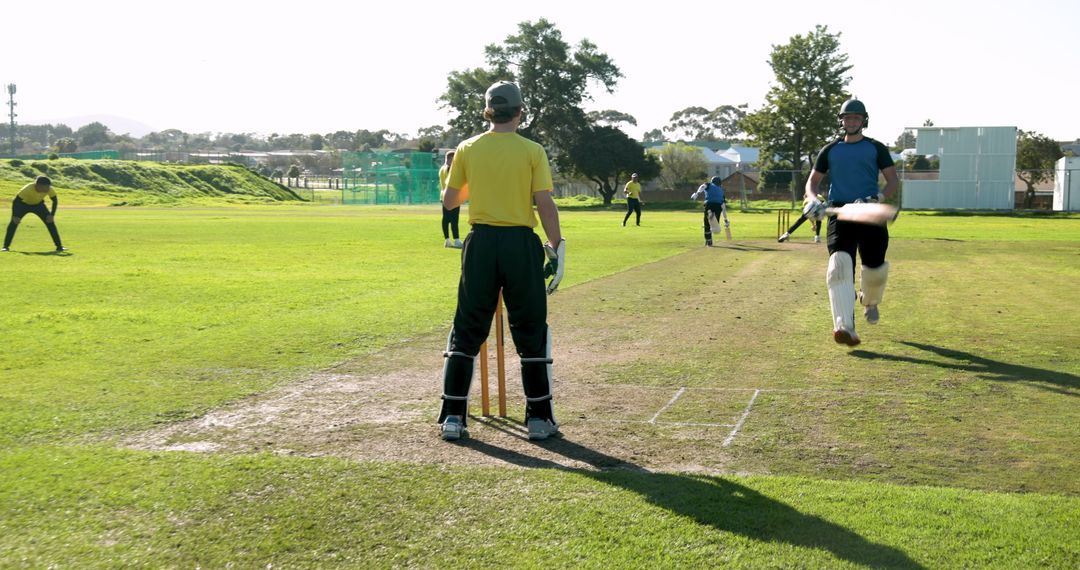 Wicket Keeper in Cricket Match on Sunny Outdoor Field