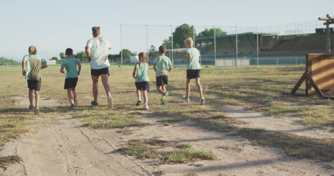 Group of Children Running Outdoors on Athletic Field - Free Images, Stock Photos and Pictures on Pikwizard.com