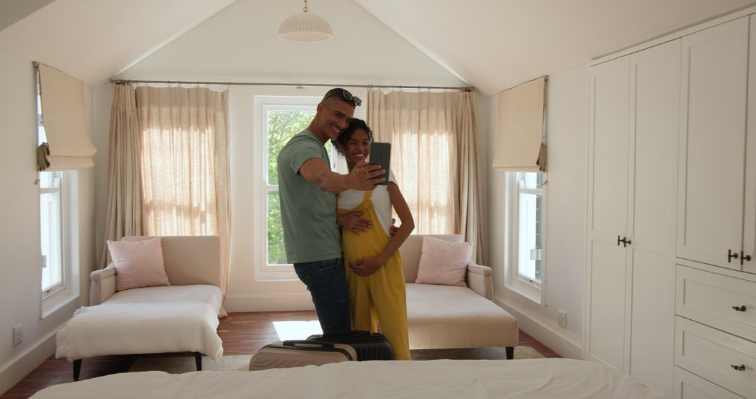 Couple Taking Selfie While Preparing for Vacation in Bright Bedroom