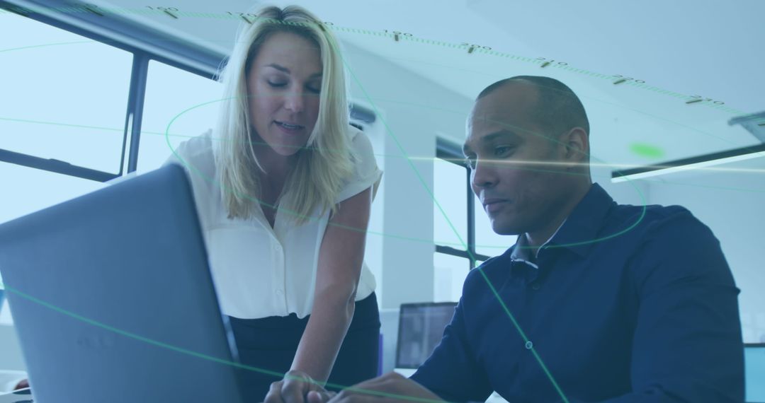 Collaborative Professionals Analyzing Data on Laptop in Modern Office