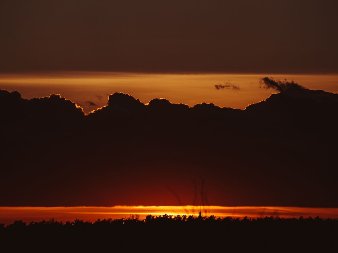 Dramatic Sunset Silhouetting Clouds over Horizon - Free Images, Stock Photos and Pictures on Pikwizard.com