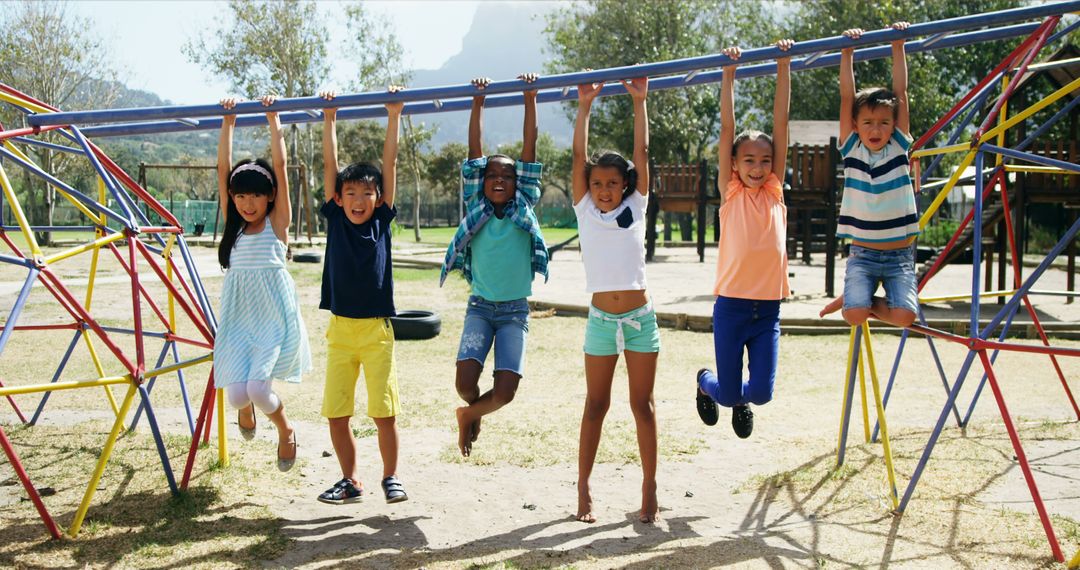 Group of Happy Children Hanging on Monkey Bars at Playground - Free Images, Stock Photos and Pictures on Pikwizard.com