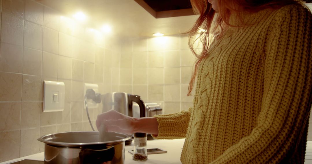 Woman Cooking at Home in Cozy Kitchen in Yellow Sweater - Free Images, Stock Photos and Pictures on Pikwizard.com