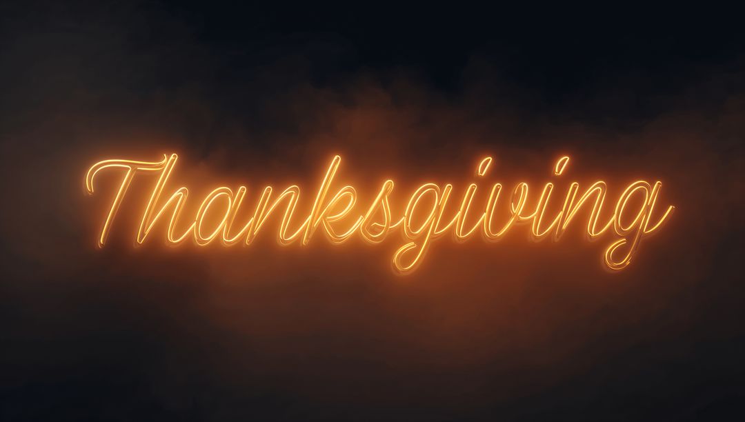 Glowing Thanksgiving Neon Script Sign Casting Warm Amber Light Through Smoky Fog Backdrop