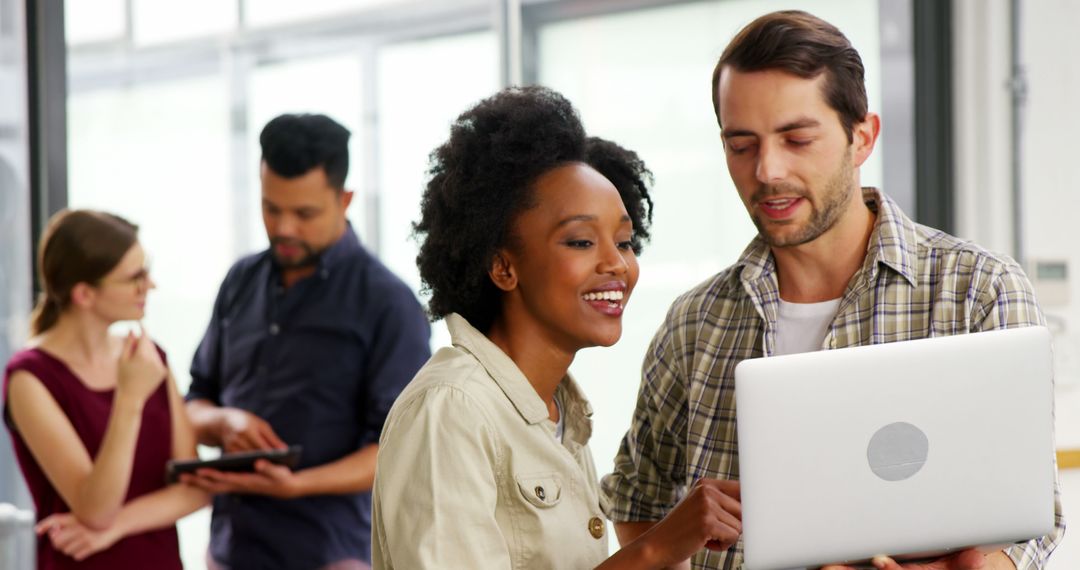 Diverse Office Team Collaborating with Laptops