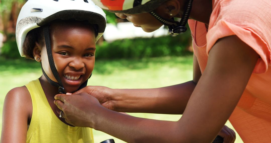 Mother Securing Bicycle Helmet on Daughter Outdoors - Free Images, Stock Photos and Pictures on Pikwizard.com