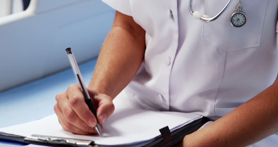 Doctor Writing Patient Report in Hospital - Free Images, Stock Photos and Pictures on Pikwizard.com