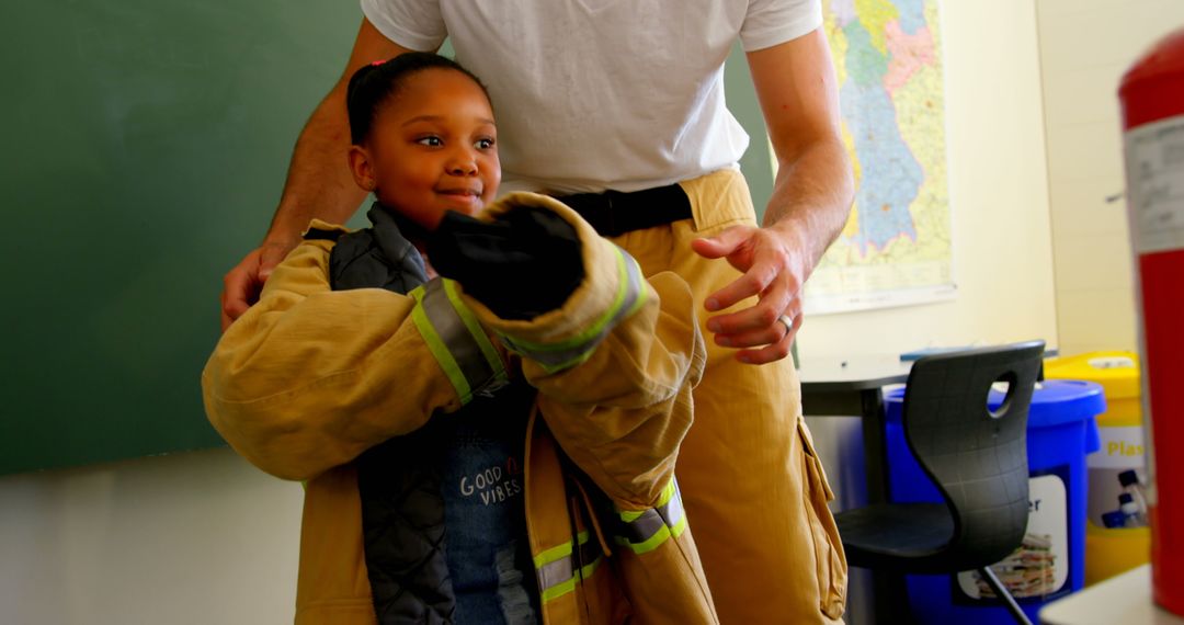 Firefighter Assisting Smiling Schoolgirl with Uniform