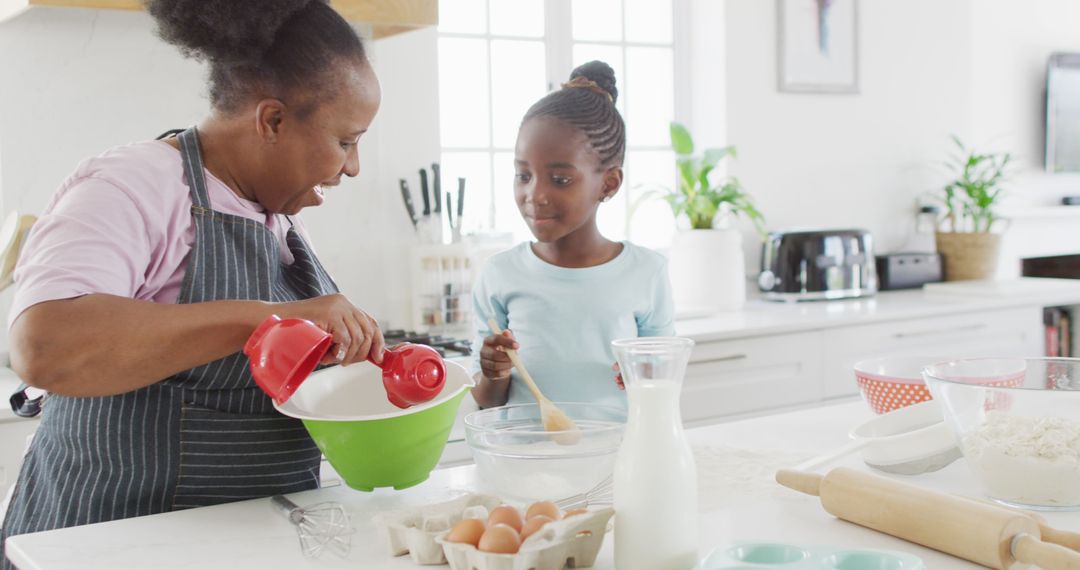 Happy African American Grandmother and Granddaughter Baking Together in Kitchen - Free Images, Stock Photos and Pictures on Pikwizard.com