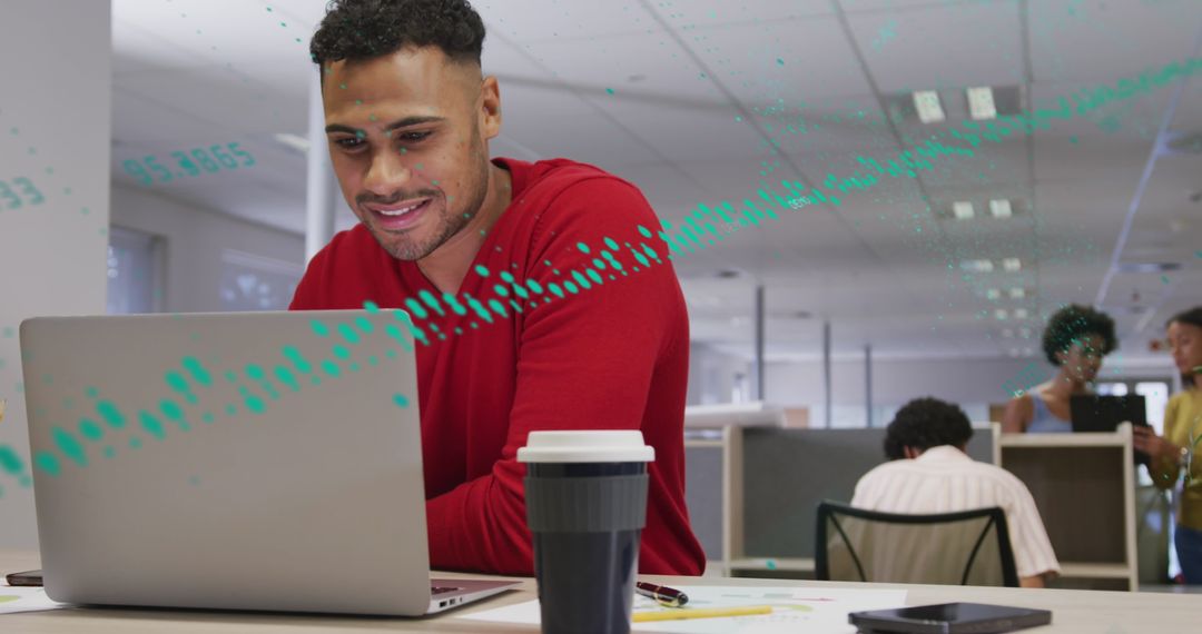 Focused Businessman Analyzing Data on Laptop at Office Desk