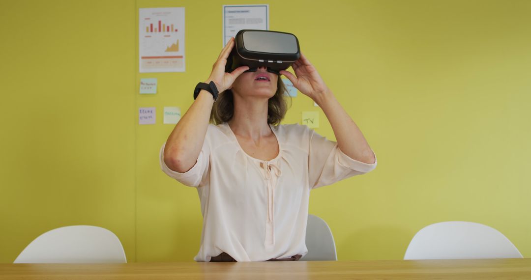 Woman Experiencing Virtual Reality With VR Headset in Office - Free Images, Stock Photos and Pictures on Pikwizard.com