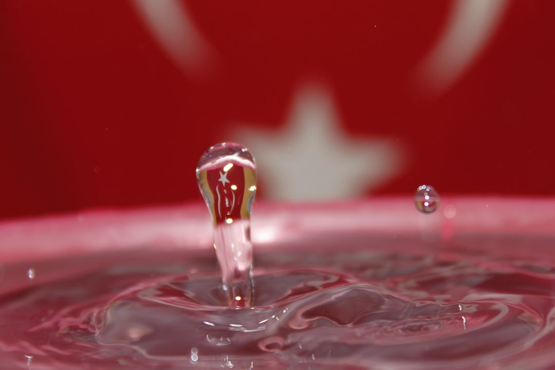 Water Droplet Against Blurred Red Background with Star - Free Images, Stock Photos and Pictures on Pikwizard.com