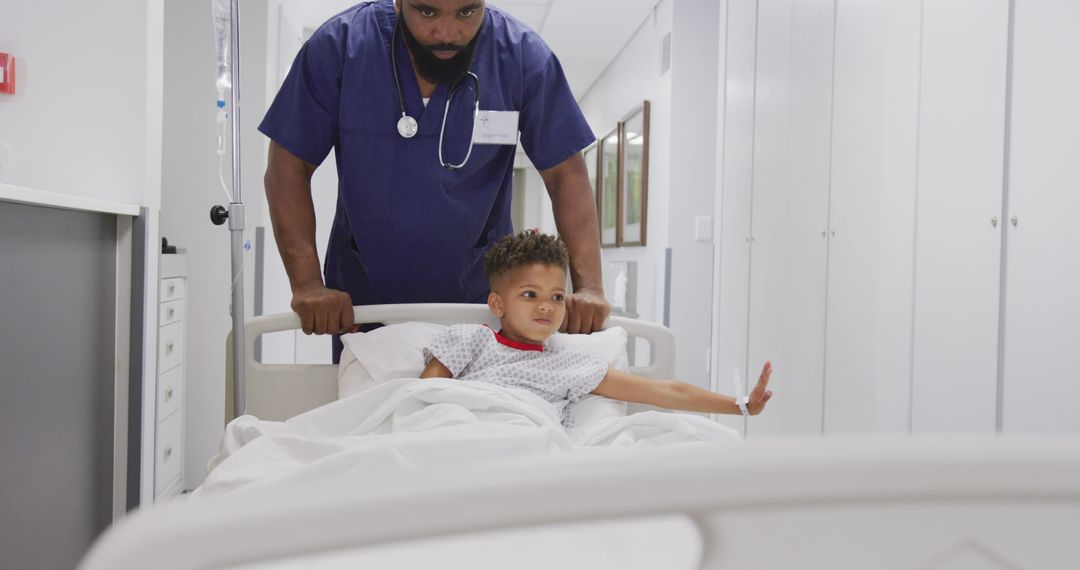 African american male doctor walking with child patient laying in bed at hospital - Free Images, Stock Photos and Pictures on Pikwizard.com