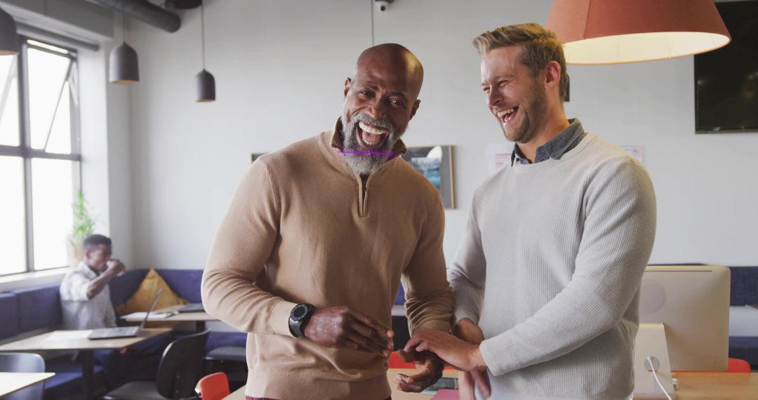 Colleagues Sharing a Congratulatory Moment in Modern Office Space