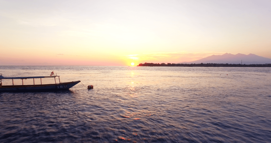 Transparent Horizon at Sunset Over Calm Sea with Boat